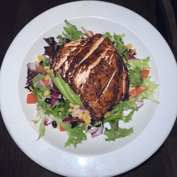 Bailey's Smokehouse BBQ chicken salad with corn, black beans, avocado, and red onion.