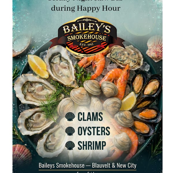 A platter of fresh oysters, clams, mussels, and shrimp on ice with lemon wedges and herbs.